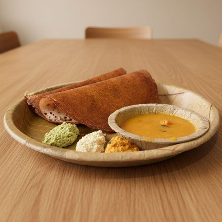 Close-up of crispy dosa showing golden brown texture and chutneys